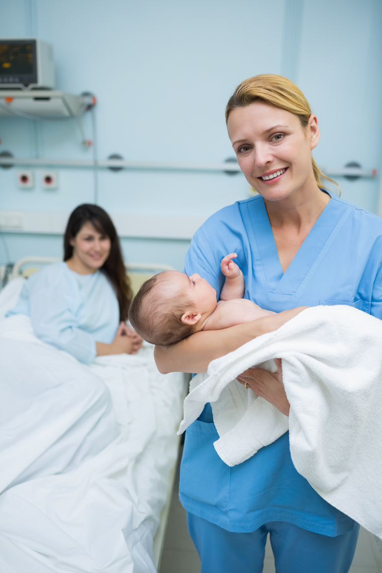 Nurse holding a new born baby