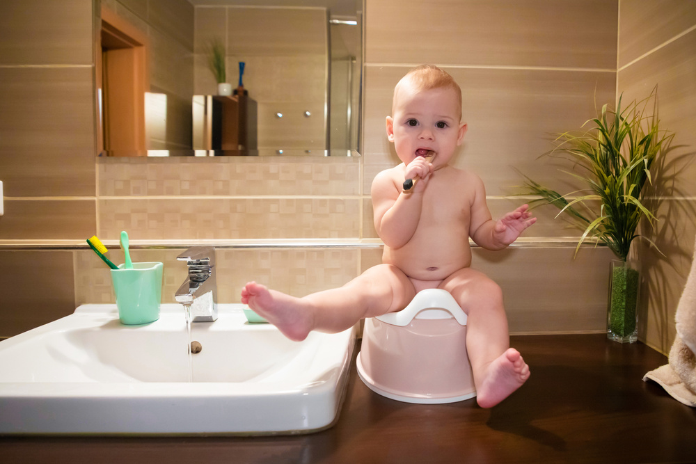 Baby Sitting on the Bathroom Counter Brushing their Teeth 